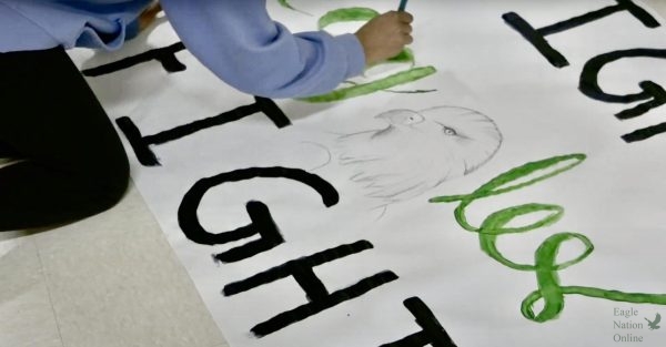 Brush in hand, a Prosper High School student council member paints a poster saying 'Fight Eagles Fight'. The group met on Sept. 10 at 4:30 to create the signs for homecoming week. Homecoming week for PHS lasted from Sept. 16 through Sept. 21. 